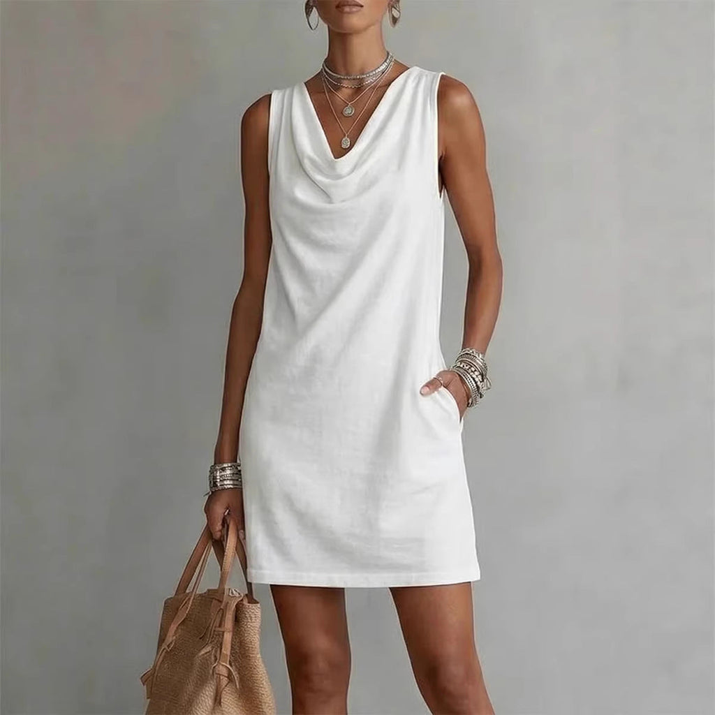 Woman wearing a solid color cowl neck sleeveless mini dress with pockets