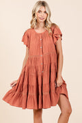 Rust colored tiered button-down dress with delicate lace detailing and ruffled tiers.