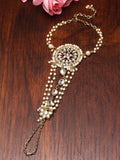 A close-up of a elegant white Kundan Hathphool hand harness for women on a brass base.