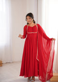 Model wearing a red faux georgette Anarkali gown with dori neck detail and matching dupatta.