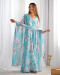 Woman wearing a sky blue floral print faux georgette Anarkali gown with a matching dupatta featuring lace border