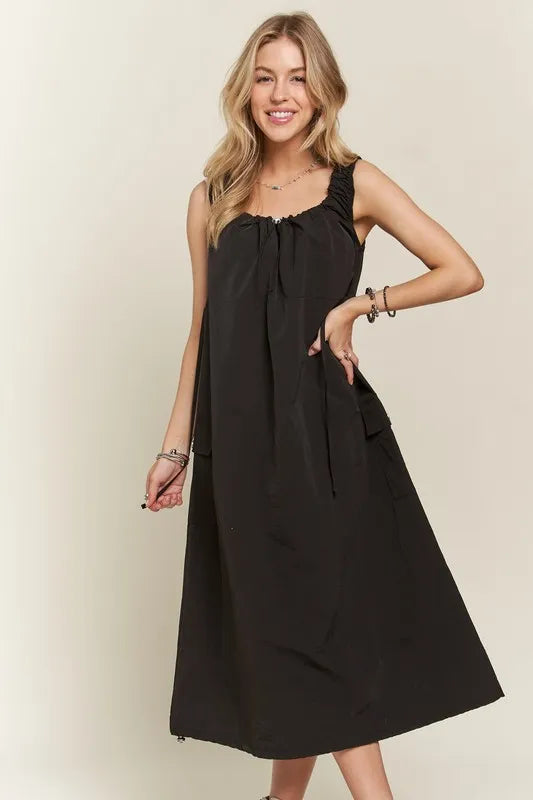 Black utility-style cargo dress with drawstring waist and slit back