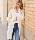 Woman wearing a relaxed-fit apricot knit cardigan with a tie front, styled for a bohemian minimalist look.