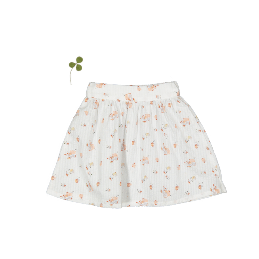 A white woven skirt with a seashell-themed floral print displayed flat against a plain background.