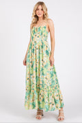 Model wearing a floral print summer maxi cami dress with a ruffled hem and smocked back.