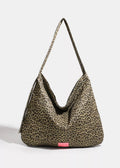 Leopard print handbag with a pink label on a white background