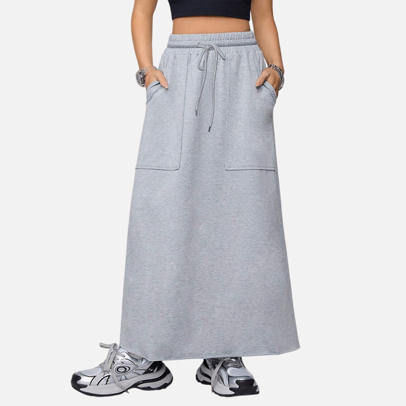 Model wearing a Classic Grey Harajuku style loose fit high-waisted maxi skirt with drawstring and side pockets, paired with a black crop top and sneakers, against a white background.