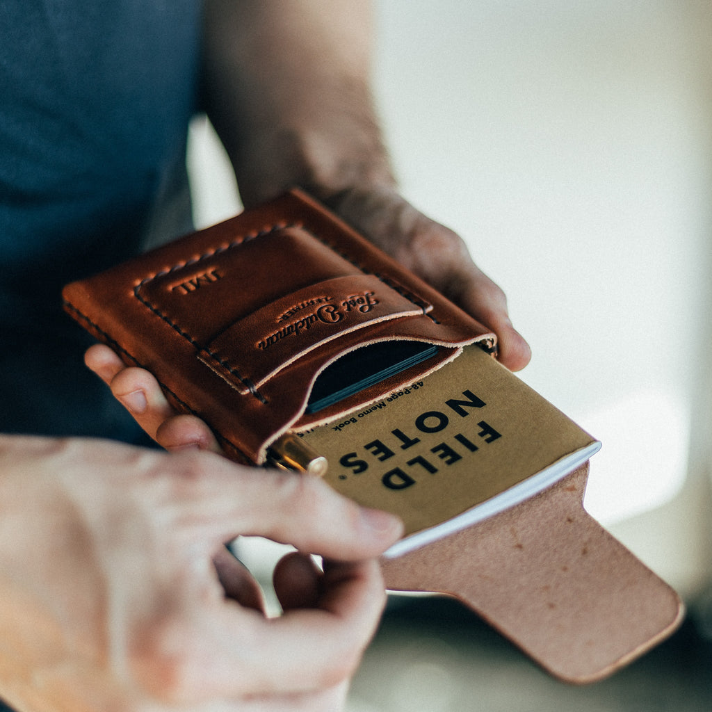 The Huckleberry tall brown leather wallet open to show notebook and card storage