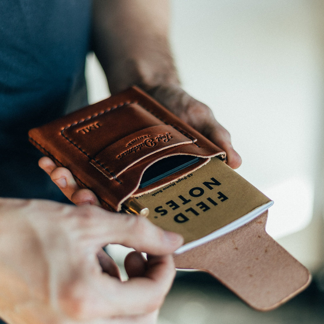 The Huckleberry tall brown leather wallet open to show notebook and card storage