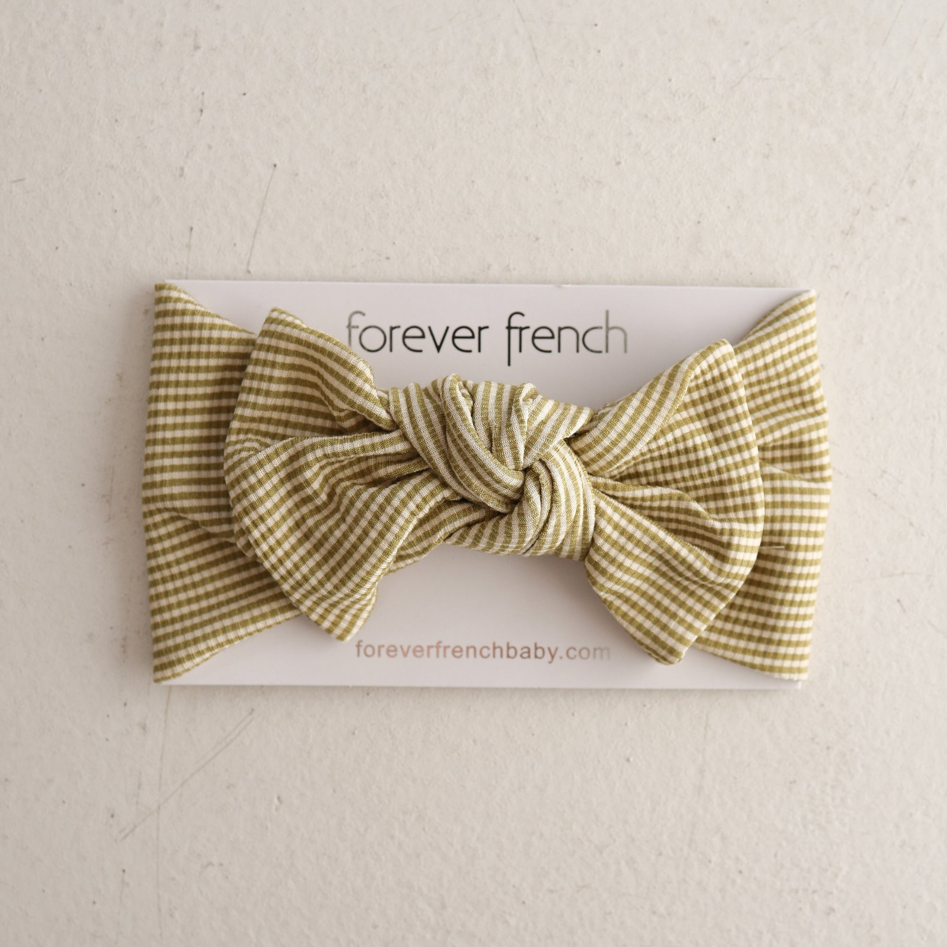 Willow Stripe Ribbed bamboo baby head wrap featuring a knotted bow design on a display card
