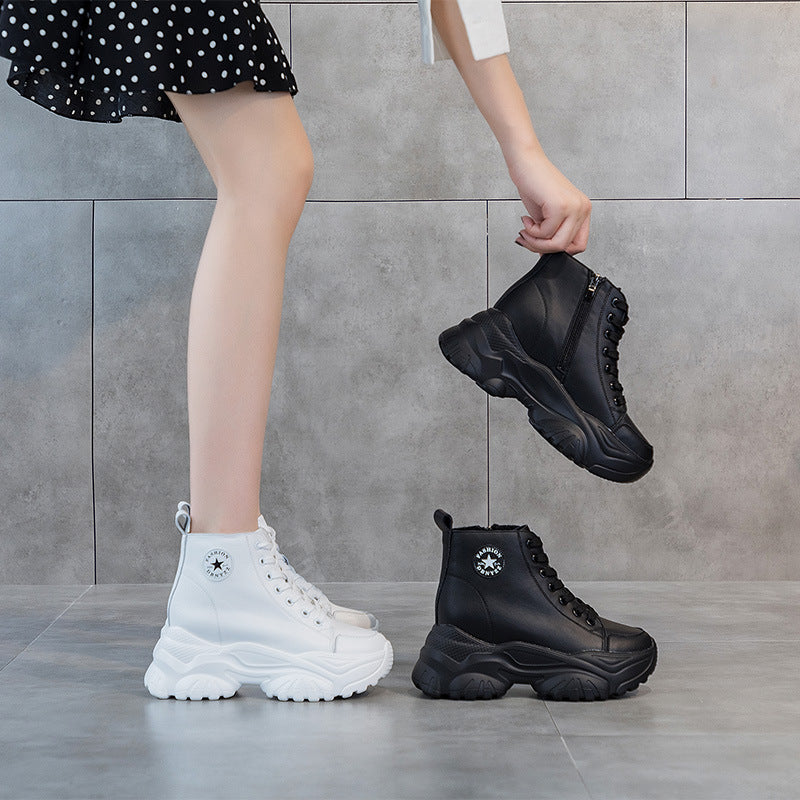 A pair of Harajuku Style women's chunky platform high-top sneakers, one white and one black, on a model's feet.