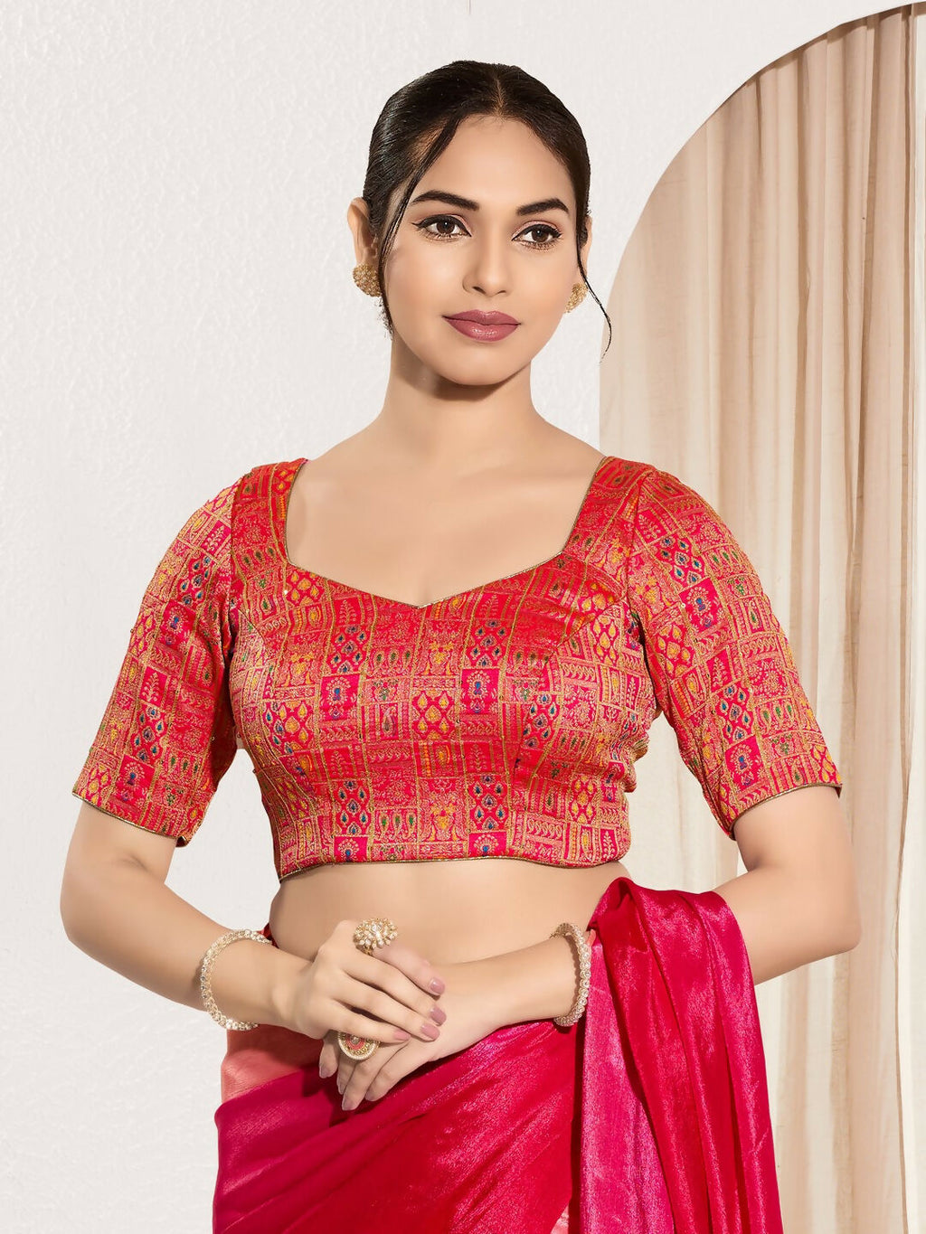 Stunning red brocade padded blouse with round neck and elbow length sleeves