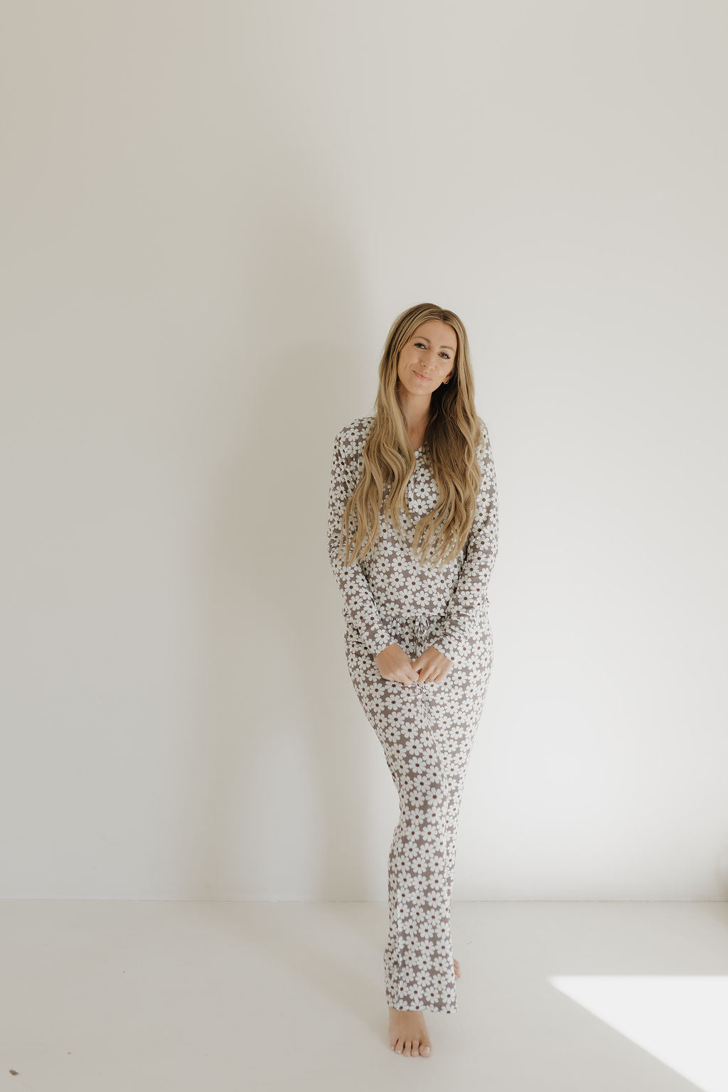 Woman wearing Darlin' print bamboo long sleeve pajama set with floral daisy pattern