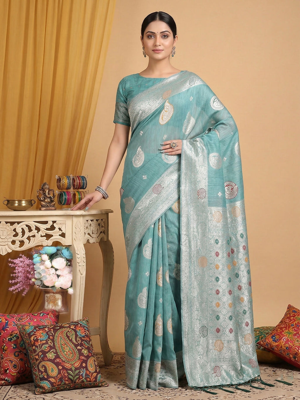 A soft sea green linen cotton saree with a matching blouse piece.