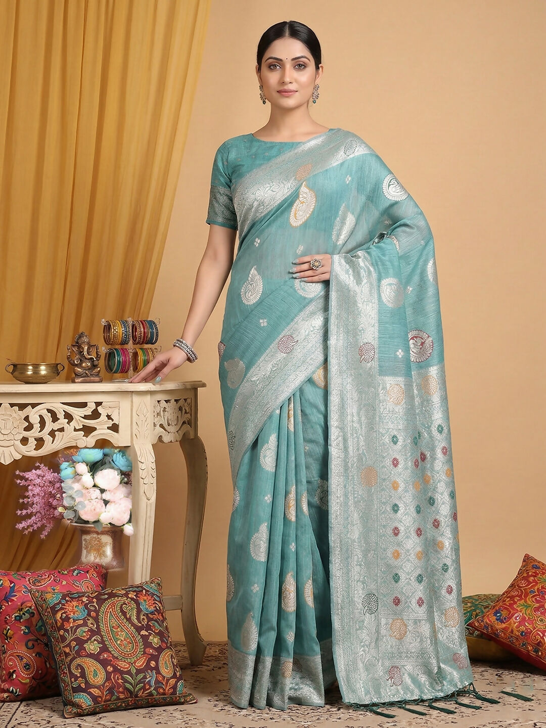 A soft sea green linen cotton saree with a matching blouse piece.