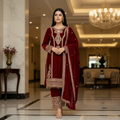 Model wearing a maroon velvet kurta set with detailed embroidery and sequence work