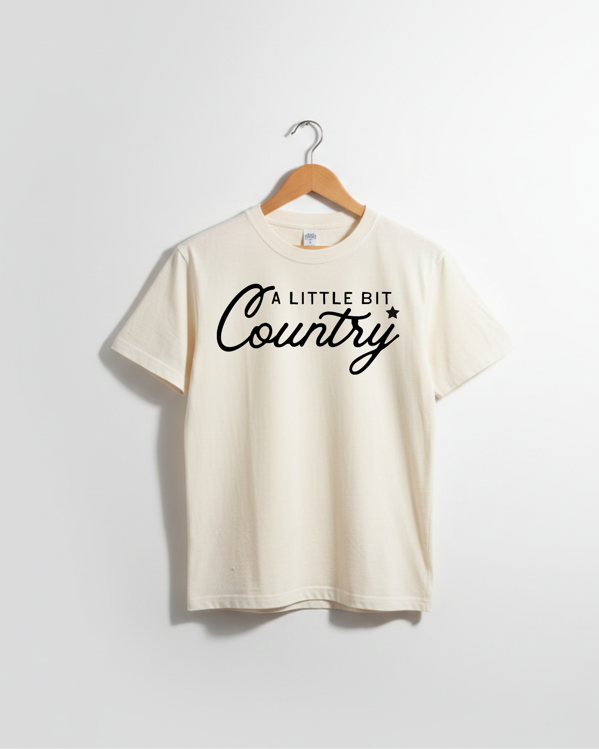 Little Bit Country kids graphic tee in solid cotton, available in white, black, and cream.