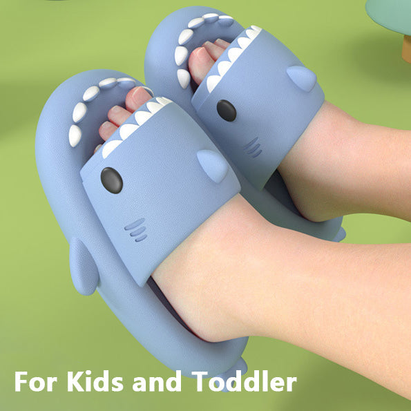 A pair of lightweight, shark-shaped slides for toddlers with an open-toe design, perfect for beach and pool use.