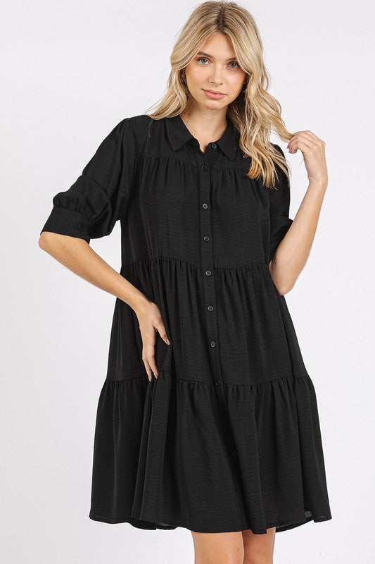 Woman wearing a button-detail collared tiered shirt dress in a classic fit