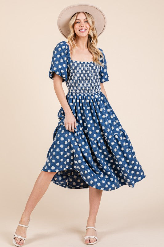Romantic midi dress with floral embroidery and puff sleeves.