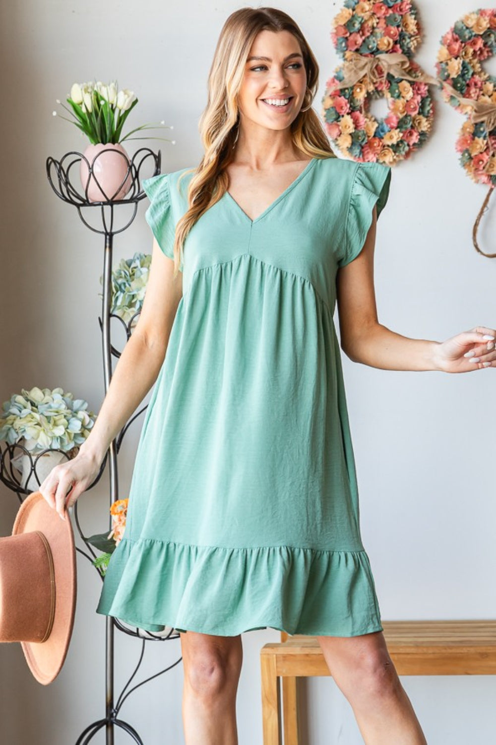 V-neck short sleeve dress with a stylish ruffled hem detail.