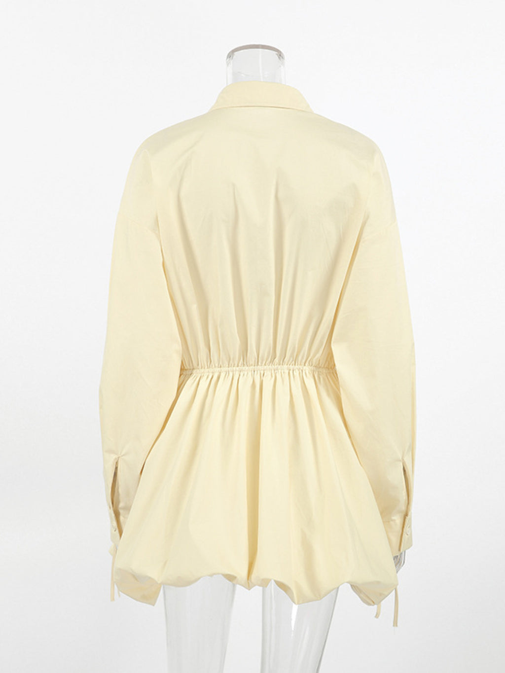 Light yellow blouse on a mannequin against a white background