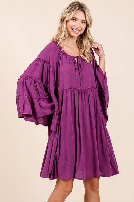 Elegant dress featuring bell sleeves and a frill tie-neck detail