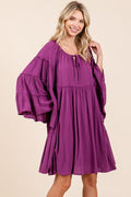 Elegant dress featuring bell sleeves and a frill tie-neck detail