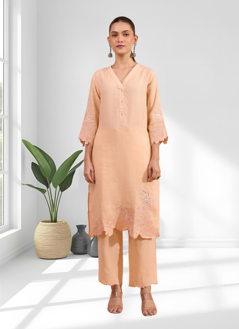 Coral linen long kurta with detailed embroidery and V-neck, paired with matching trousers.