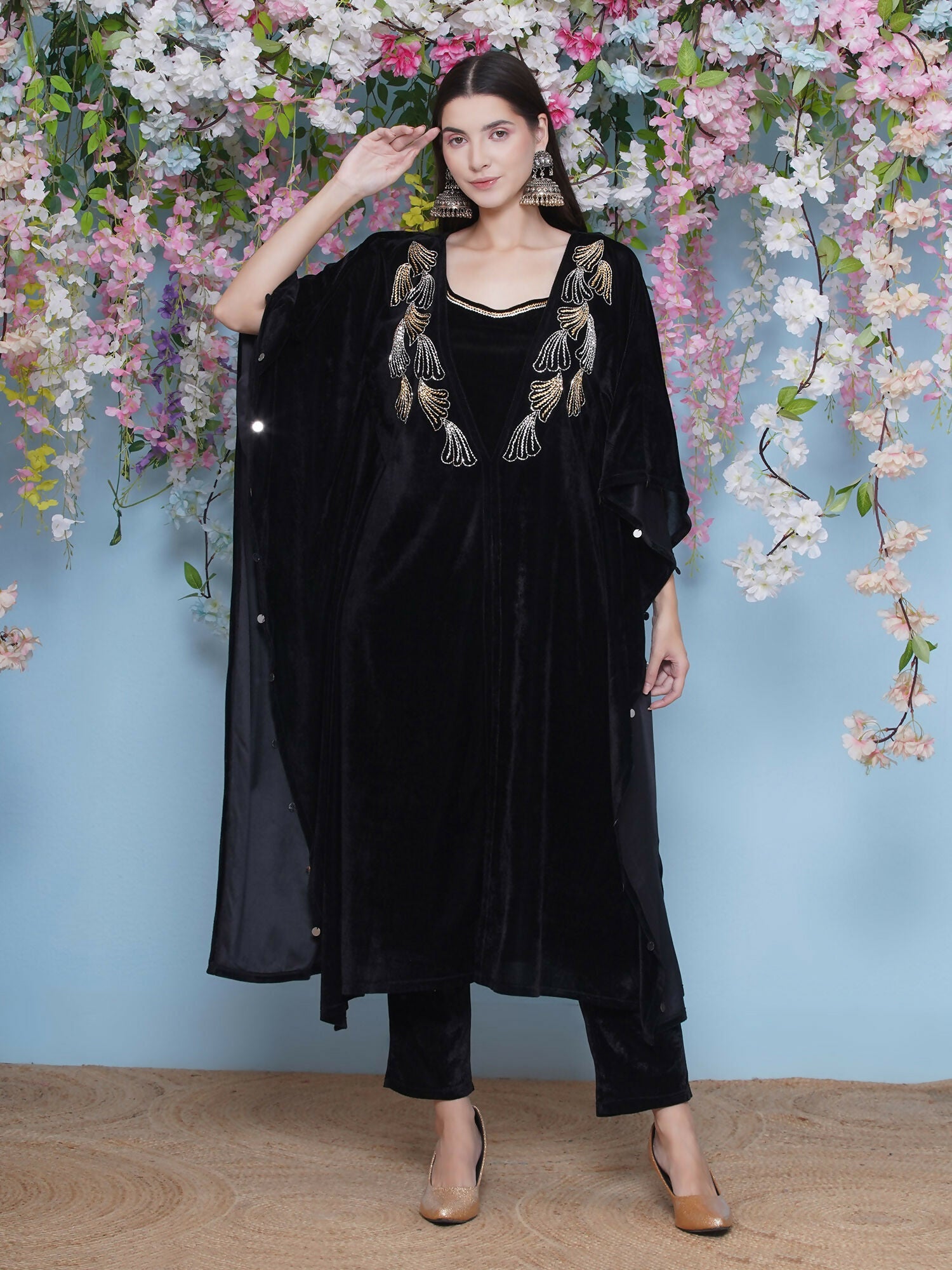 Black velvet kaftan with intricate hand embellishments, including matching inner and pant.