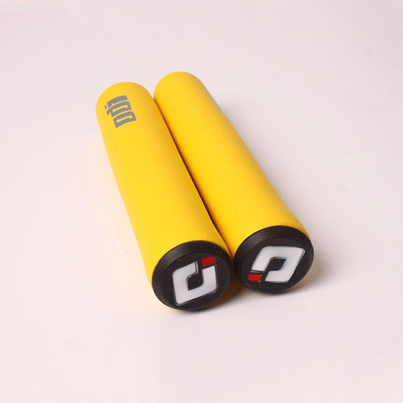 Set of non-slip, shock-absorbing bicycle handlebar grips in bright colors with black end caps.