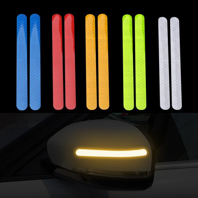 Set of two geometric reflective car stickers in various colors applied to a rearview mirror.