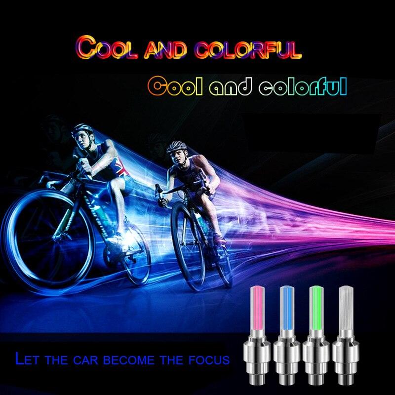 Colorful LED lights installed on bicycle tire valve stems during a night ride