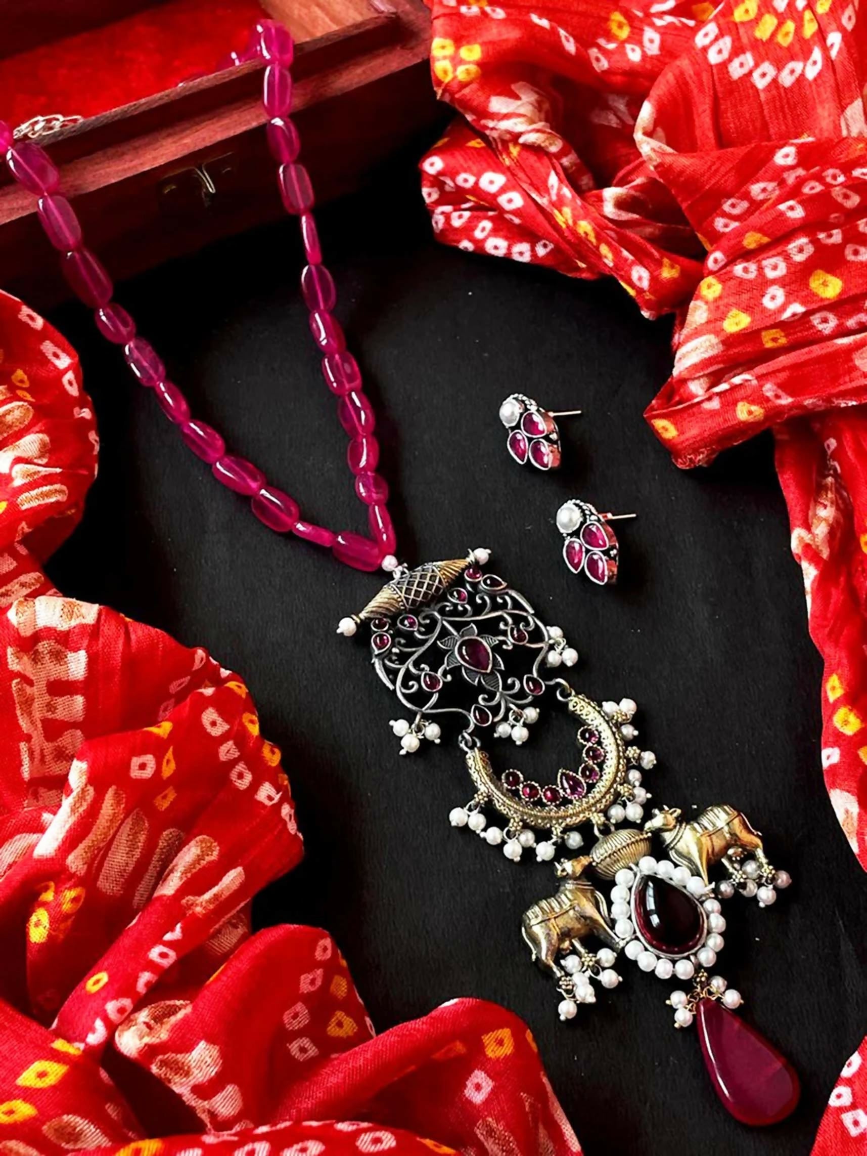A beautiful pink beaded mala necklace and pendant set with matching earrings on a clean background.