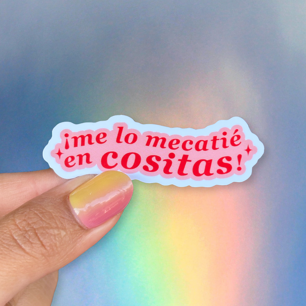 Sticker with text held by a hand against a colorful blurred background