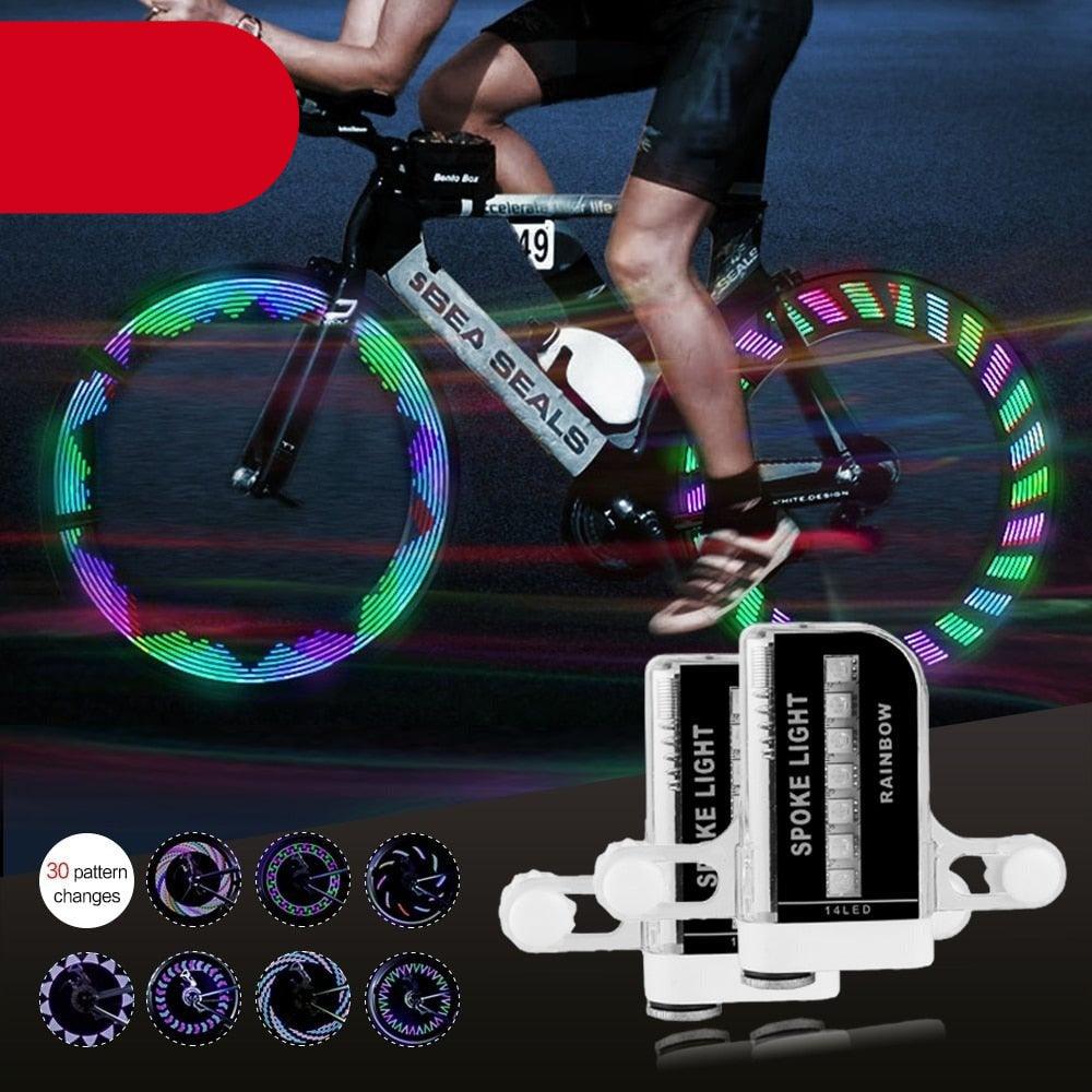 Colorful RGB LED bicycle spoke lights attached to a mountain bike wheel at night.