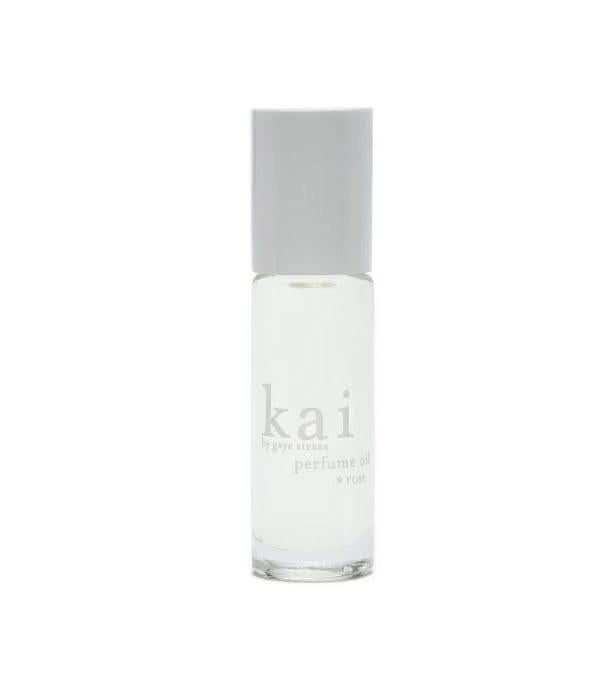 Rose perfume oil roll-on vial in minimal clear glass packaging.