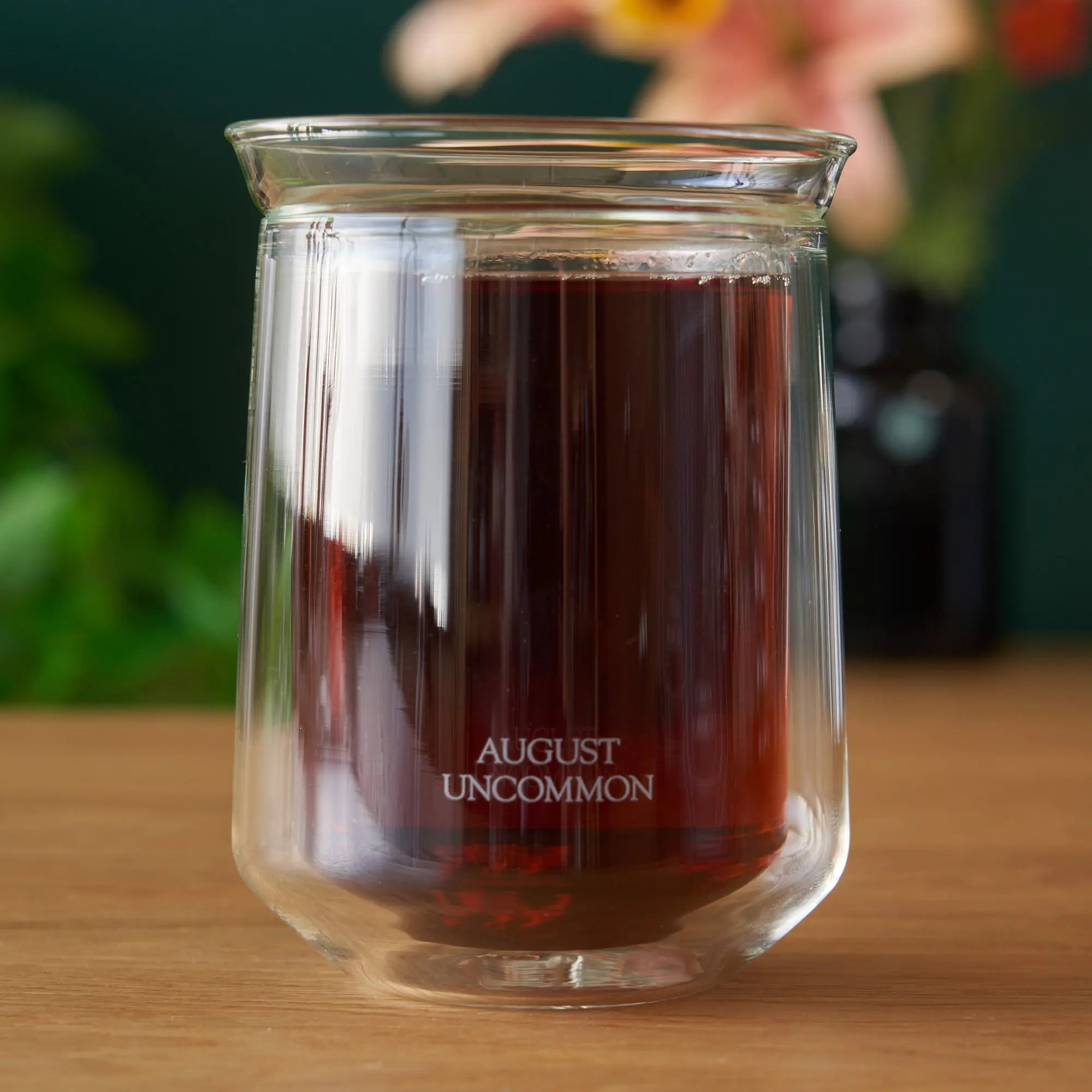 A clear double-walled glass cup perfect for tea tasting, featuring a flared rim.