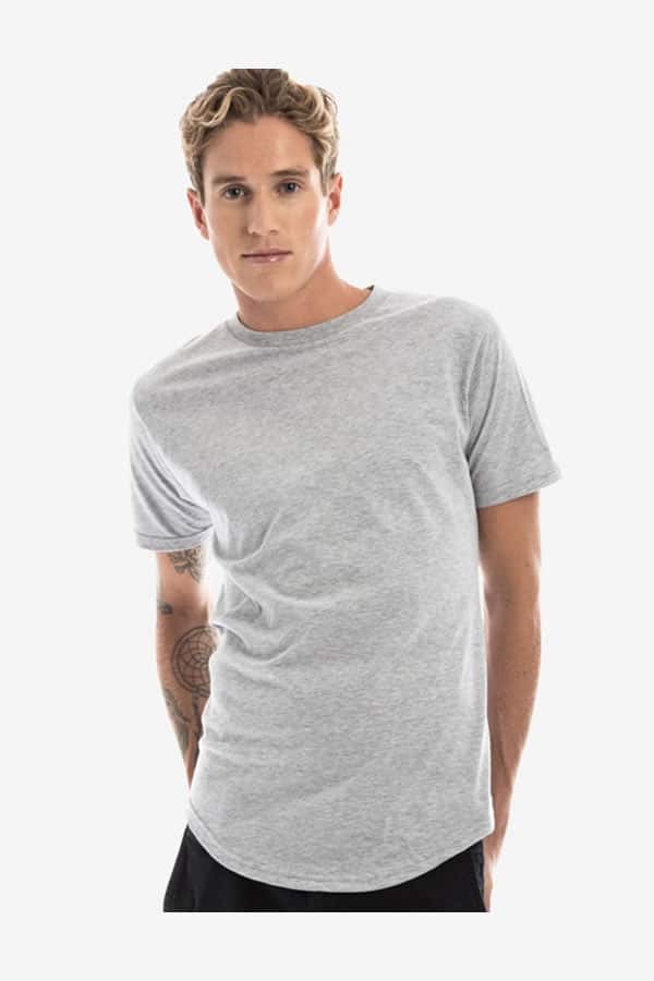 A man wearing a heather grey long-line t-shirt with a curved scalloped hem