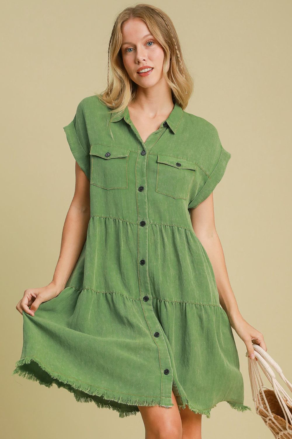 A stylish green denim button-down shirt dress with a collared neckline and relaxed fit.