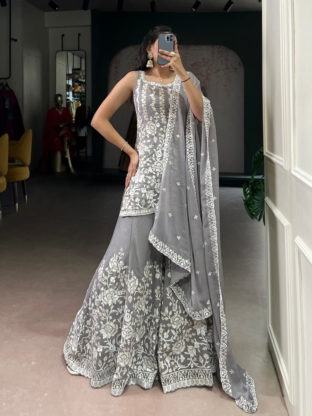 Woman wearing a Star Georgette Kurta Palazzo set with sequins and thread embroidery work