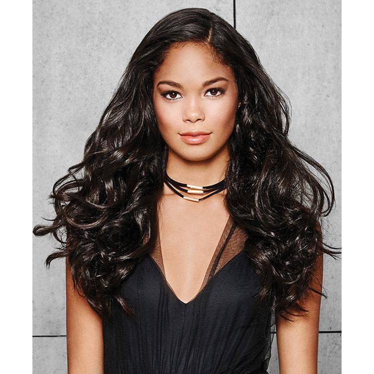 Woman wearing 22 inch wavy dark brown hair extension kit for added volume and length