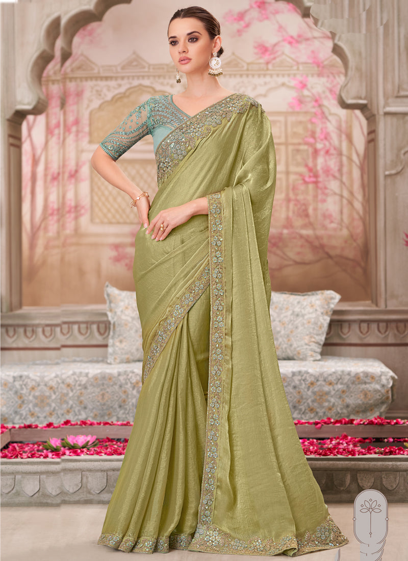 Elegant green traditional saree featuring vibrant sequin embroidery and an unstitched blouse piece