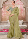Elegant green traditional saree featuring vibrant sequin embroidery and an unstitched blouse piece