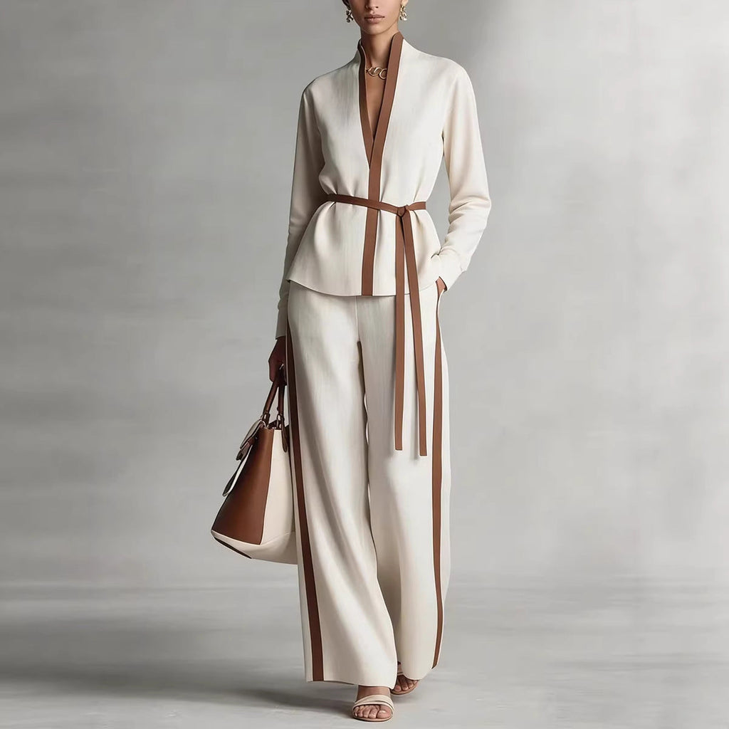 Model wearing a matching two-piece set featuring a contrast trim cardigan with a tie belt and matching wide-leg pants.