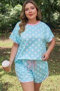Woman wearing a light blue polka dot lounge set with soft pink trim details and relaxed shorts