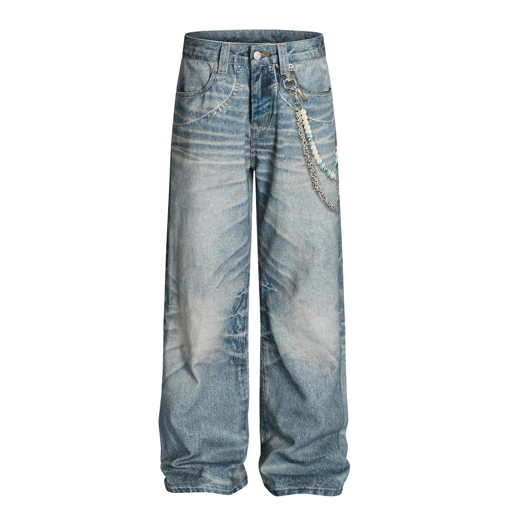 Front view of Wideboy relaxed fit jeans featuring an all-over graphic print, sandblast wash, and a hanging decorative beaded chain.
