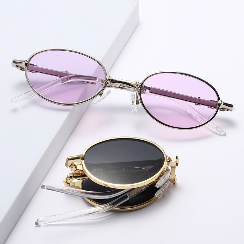 Women's foldable small frame sunglasses in shiny gold and nickel with tinted lenses
