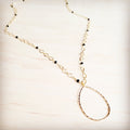 Gold-tone infinity link chain necklace with black faceted bead accents and a teardrop pendant