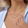 Layered stainless steel necklace featuring sparkling zircon accents on a multi-strand design.